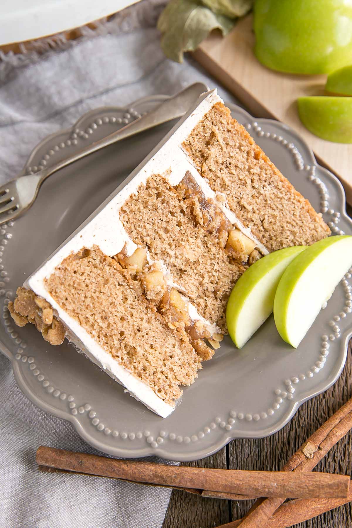 Slice of cake showing apple pie filling and crumble.