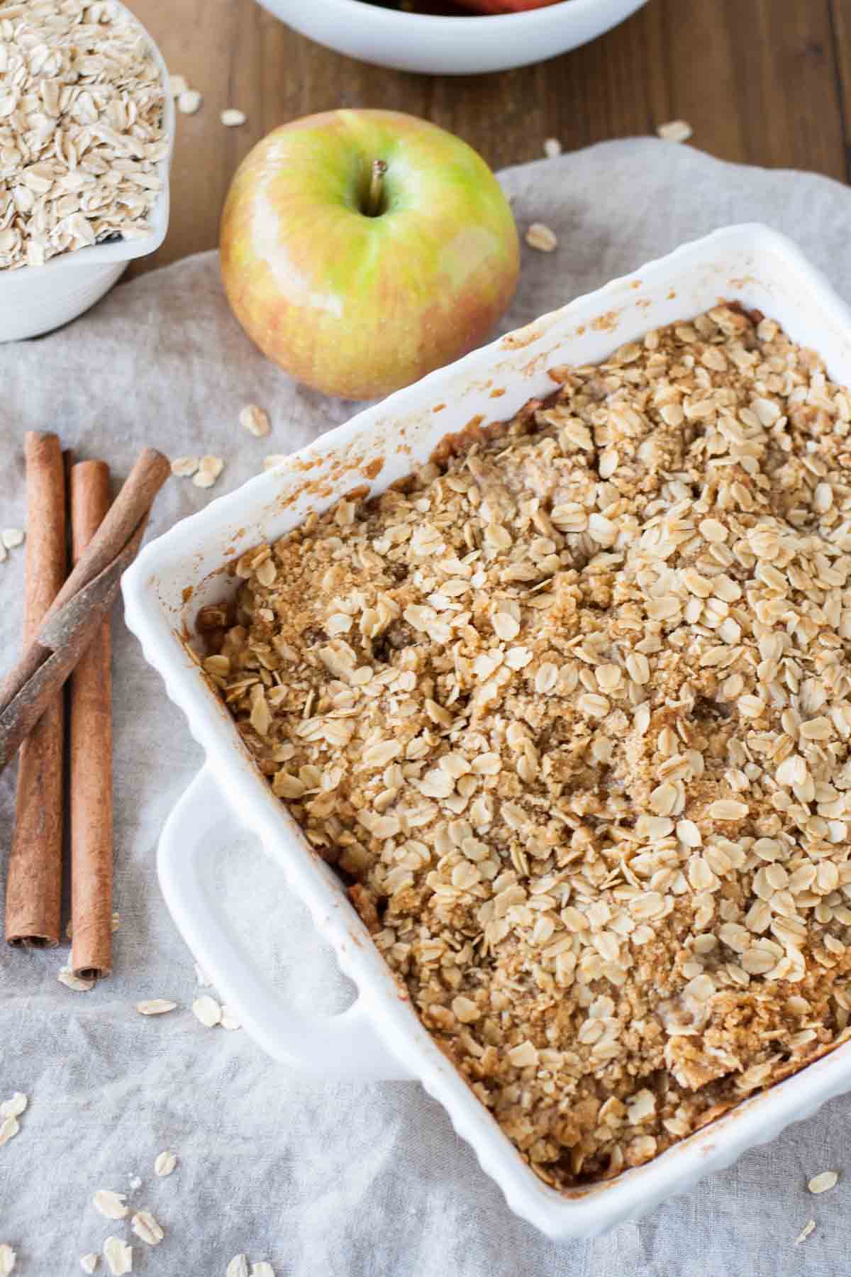 Angled shot of the apple crisp in a white dish.