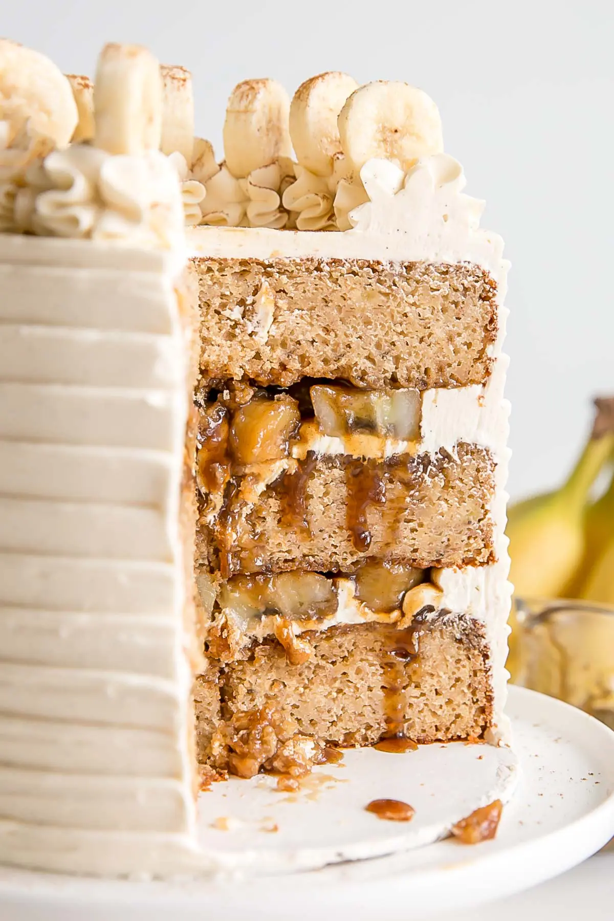 Cross section of a bananas foster cake with banana filling and fosters sauce.