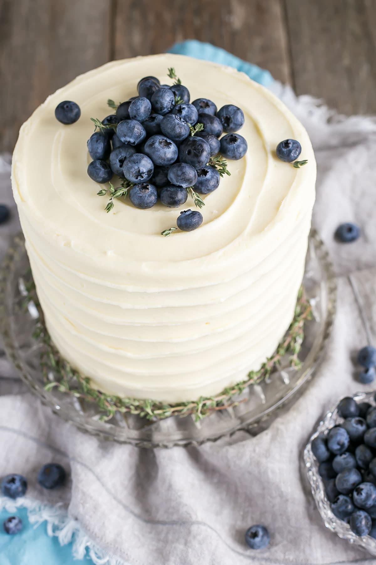 Easy banana cake recipe with blueberries and cream cheese frosting.