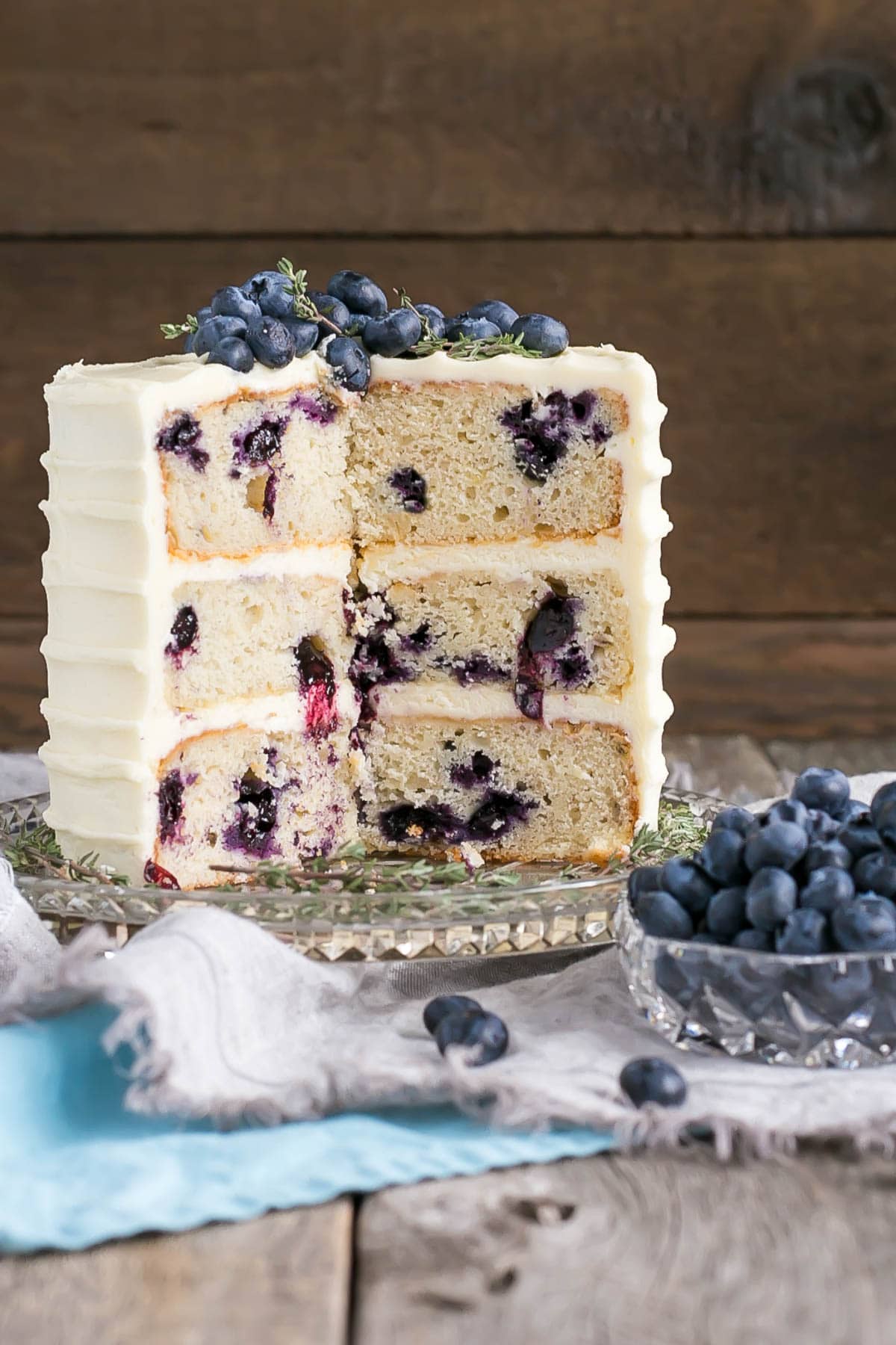 Blueberry Banana Cake with Cream Cheese Frosting with slices cut out.