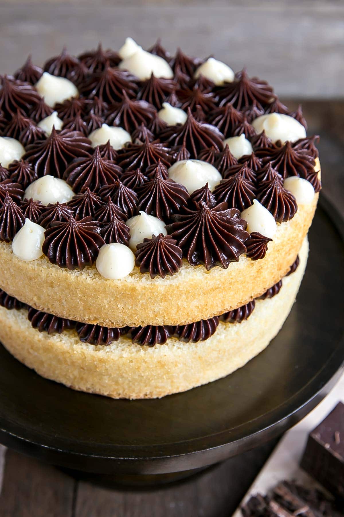 Close up of dollops on top of a Boston Cream Pie