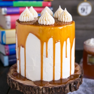 A slice of cake sitting on top of a table with books stacked behind.