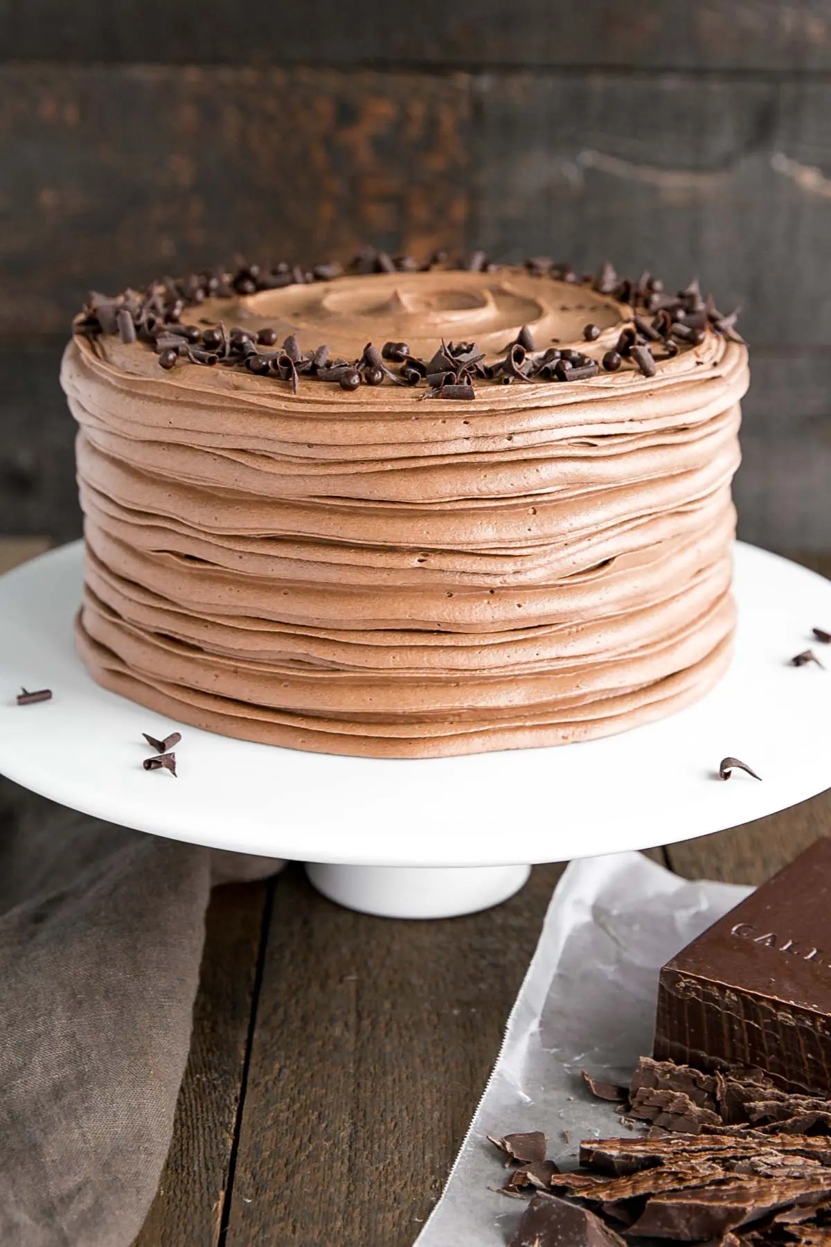 Angled shot of the cake on a white cake stand.