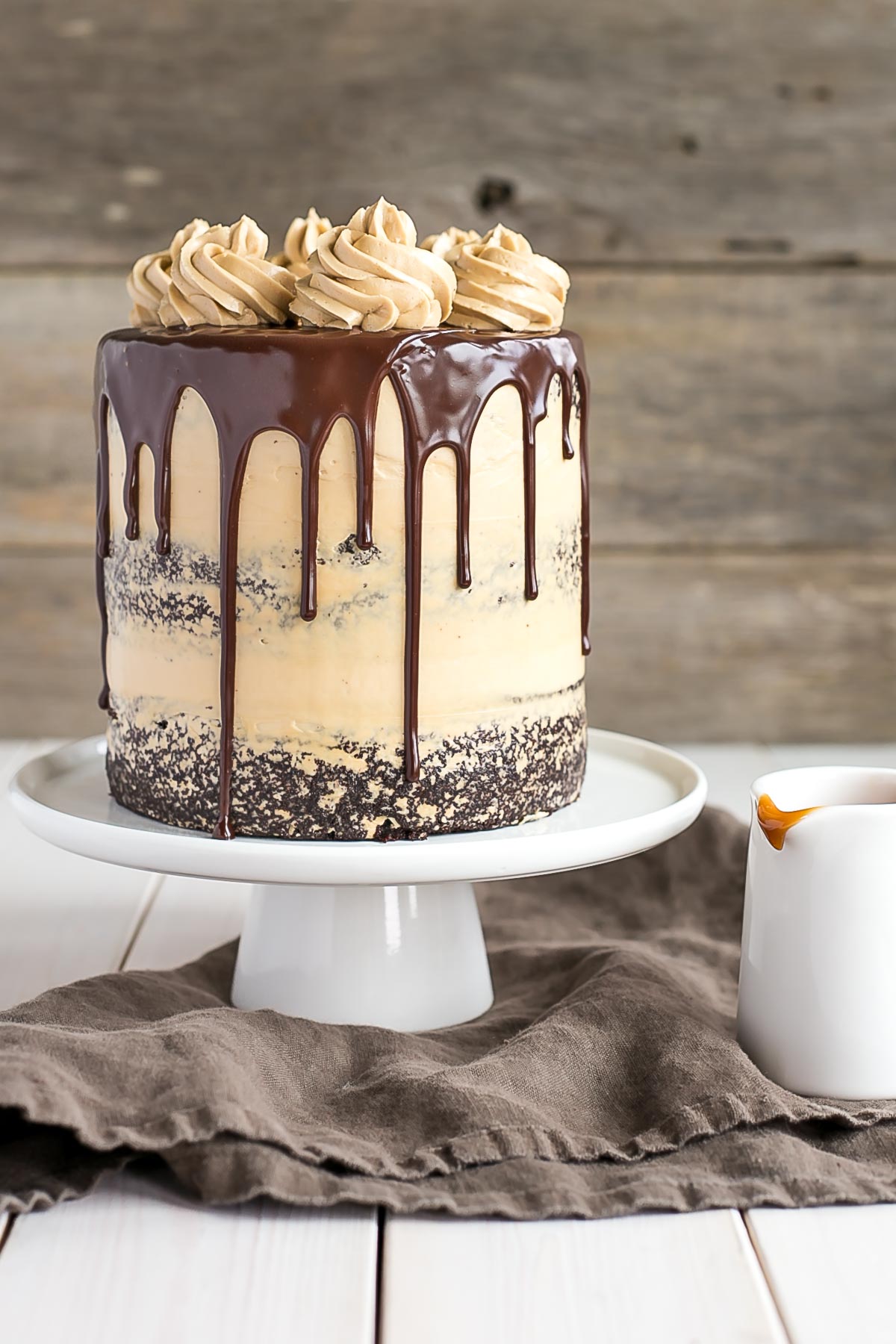 Dulce de leche buttercream on a chocolate cake with a ganache drip.