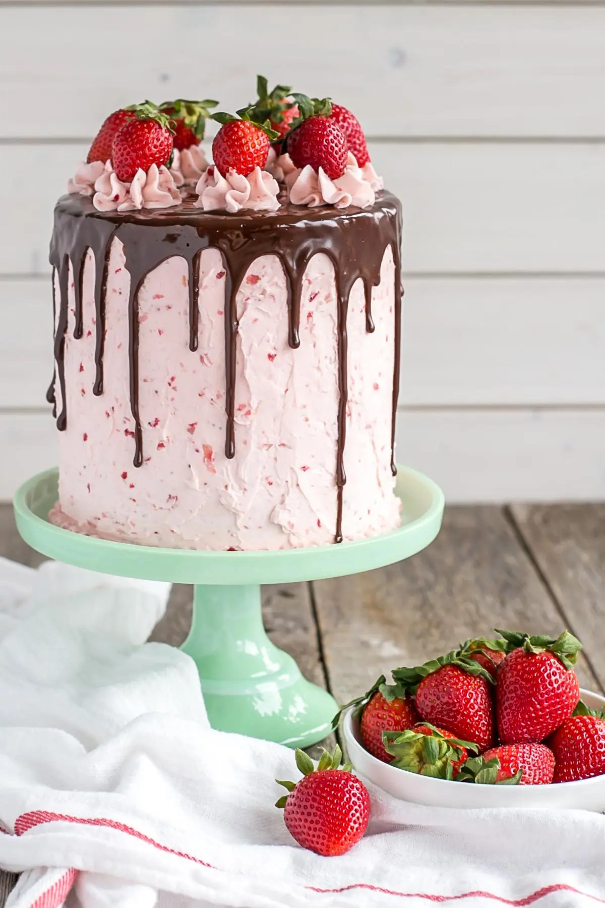 Cake on top of a mint green cake stand.