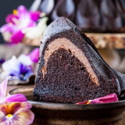 Slice of cheesecake stuffed bundt cake on a plate.