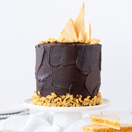 Chocolate cake with honeycomb shards on the top.