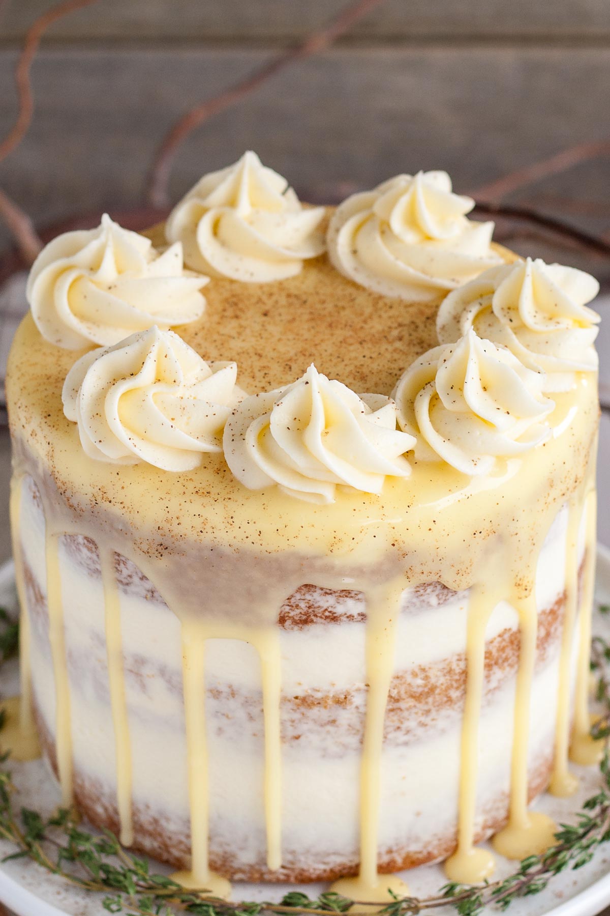 Overhead shot of eggnog cake with rosettes and white chocolate ganache