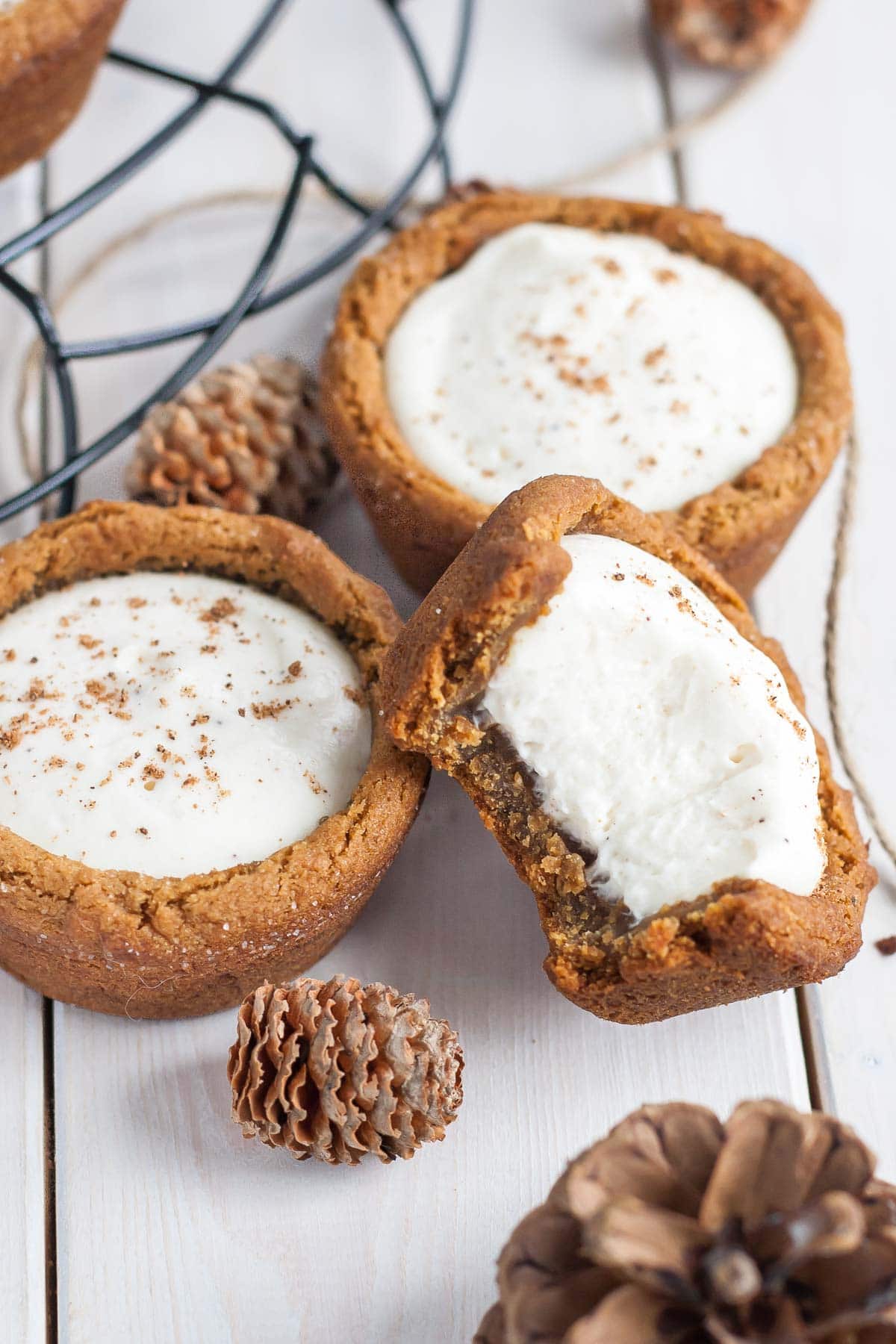 Three cookie cups, one with a bite taken out.