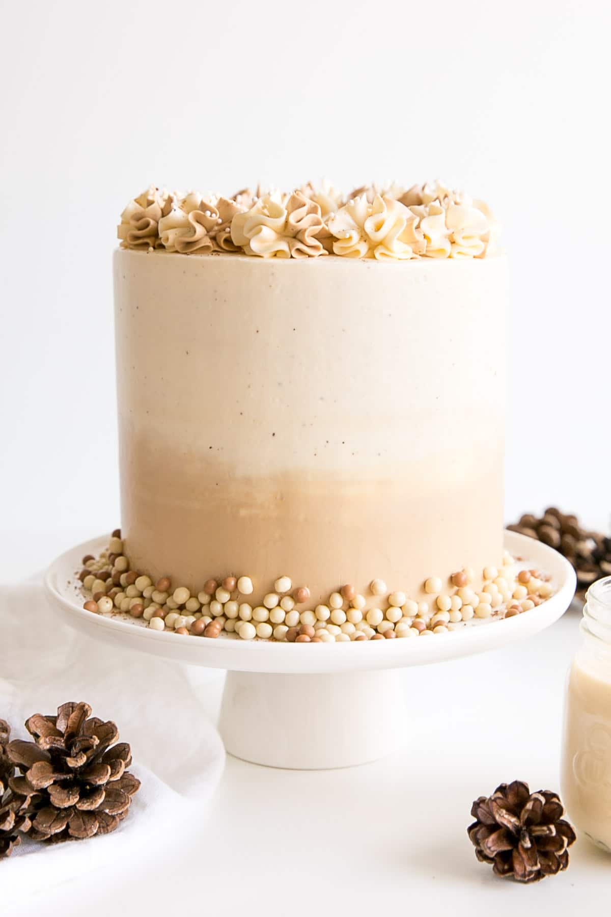 Eggnogg cake with an ombre buttercream frosting and rosettes.