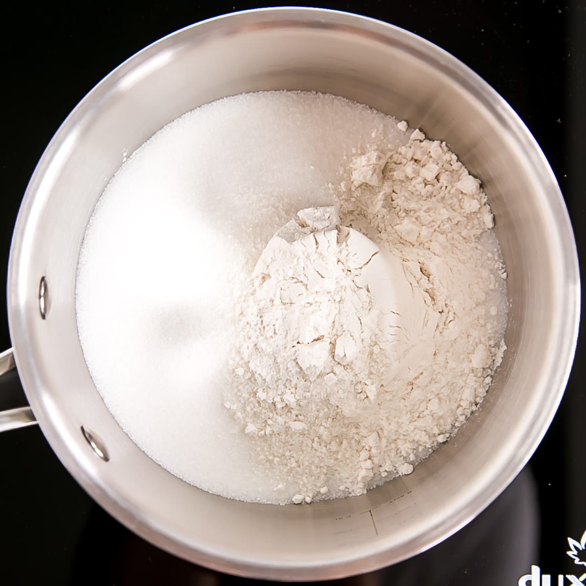 Flour, sugar, and salt in a pot.