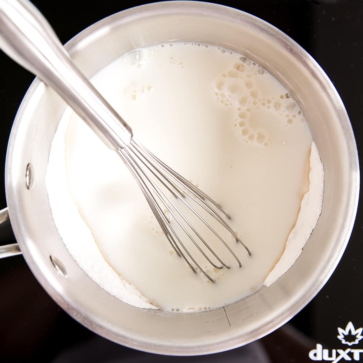 Milk added to the pot with the flour, sugar, and salt.