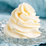 Ermine frosting piped into a swirl on a glass dish.