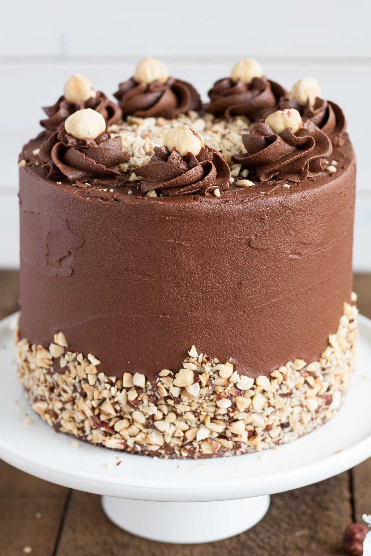 Close up of the side of the cake showing the rosettes and hazelnuts.