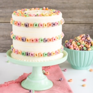 A cake sitting on a mint green cake stand.