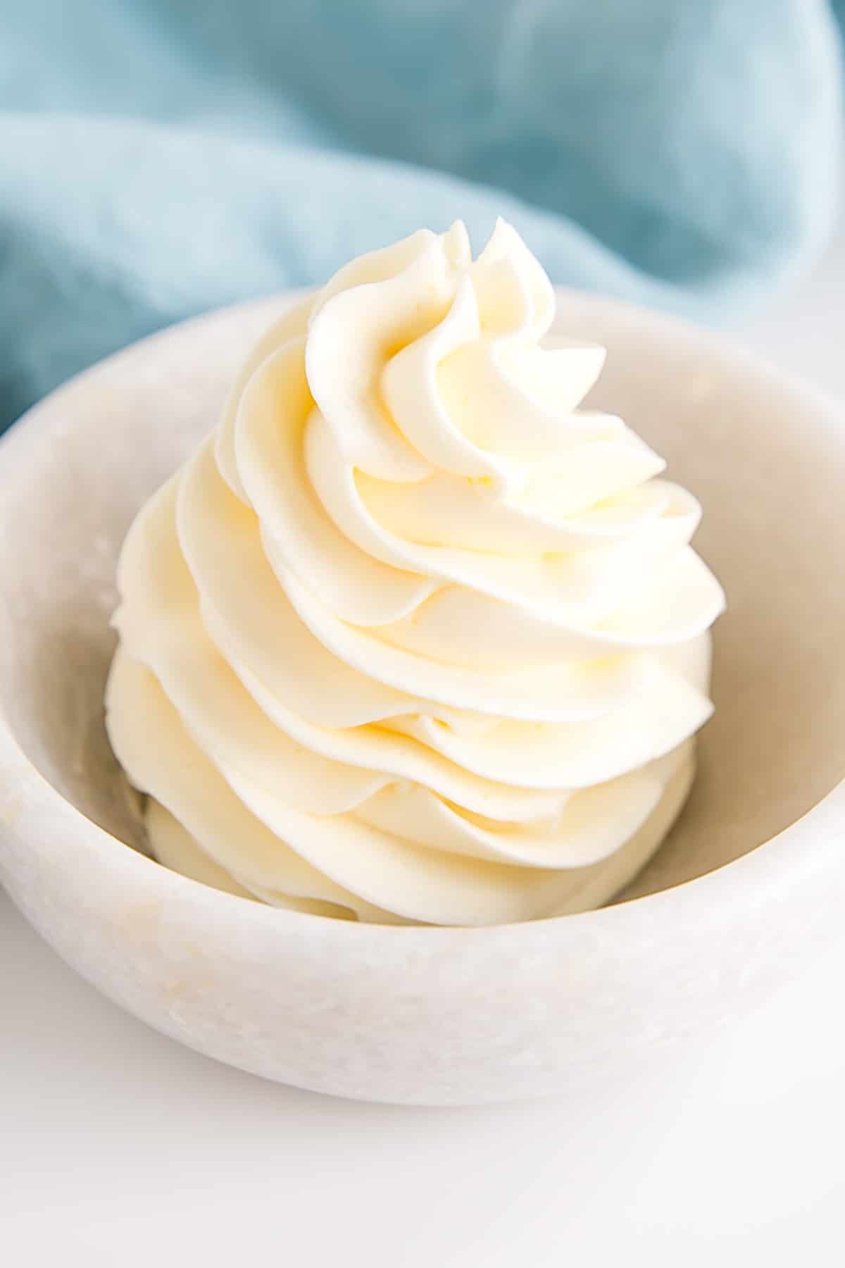 German buttercream piped rosette in a small bowl.