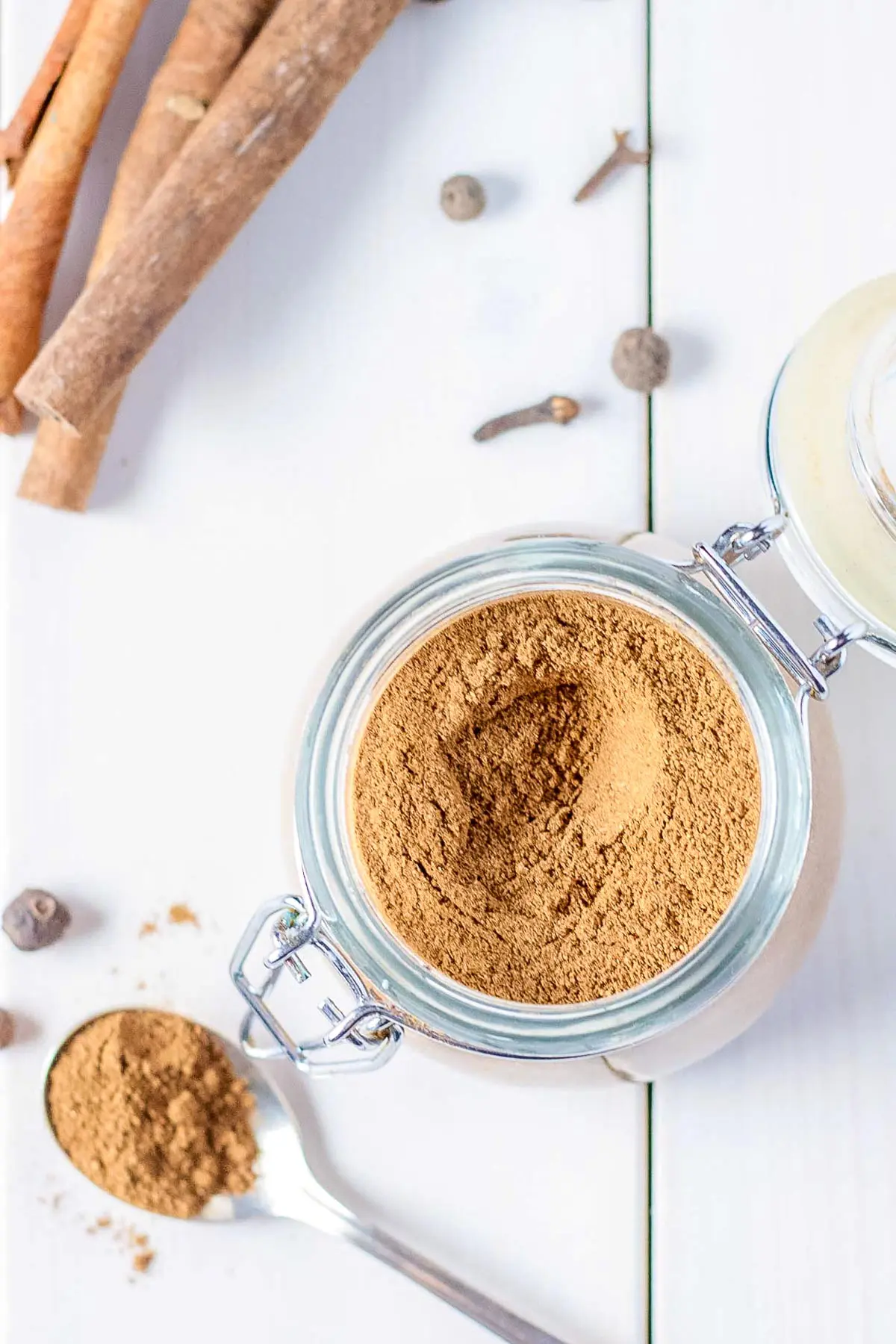 Overhead shot of the spice in a jar on a white table.