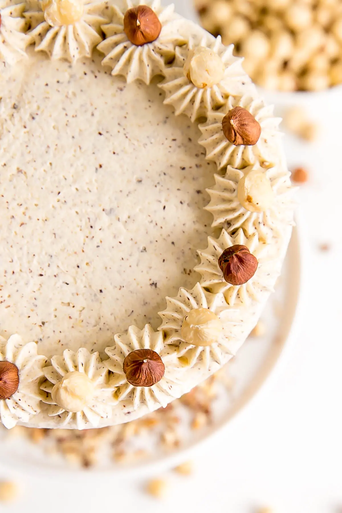 Overhead shot of the cake showing dollops and hazelnuts.