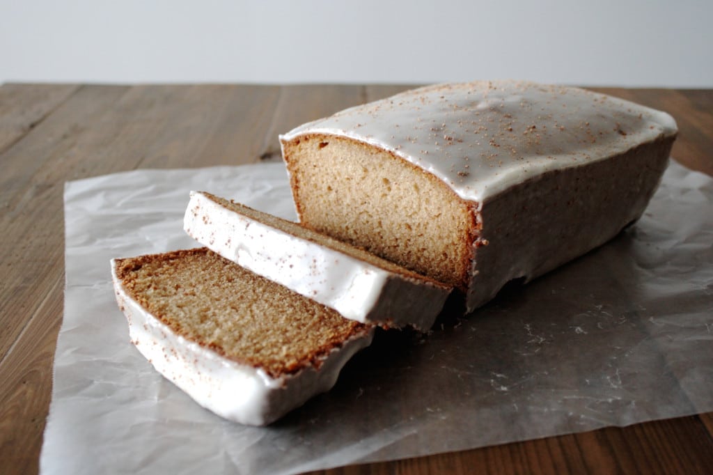 Loaf on a wooden table with some slices cut out.