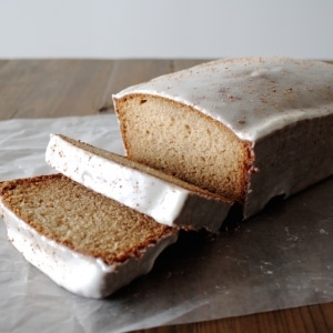 Loaf on a wooden table with some slices cut out.