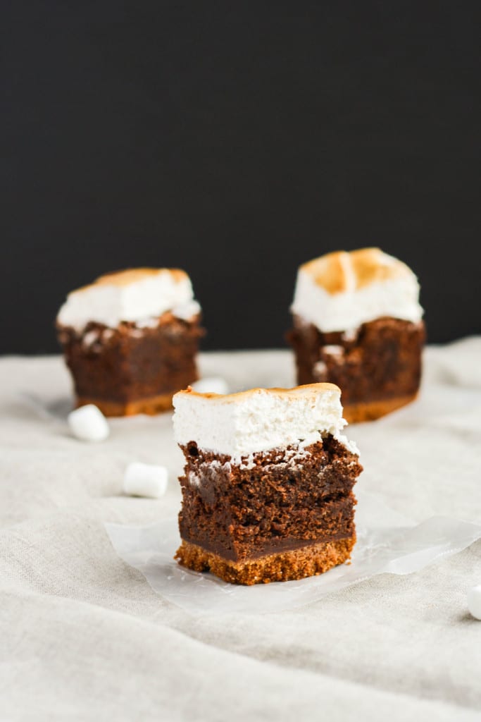 Three smores brownies on a black background.