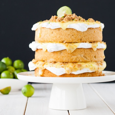 Cake on a white cake stand and a black background.