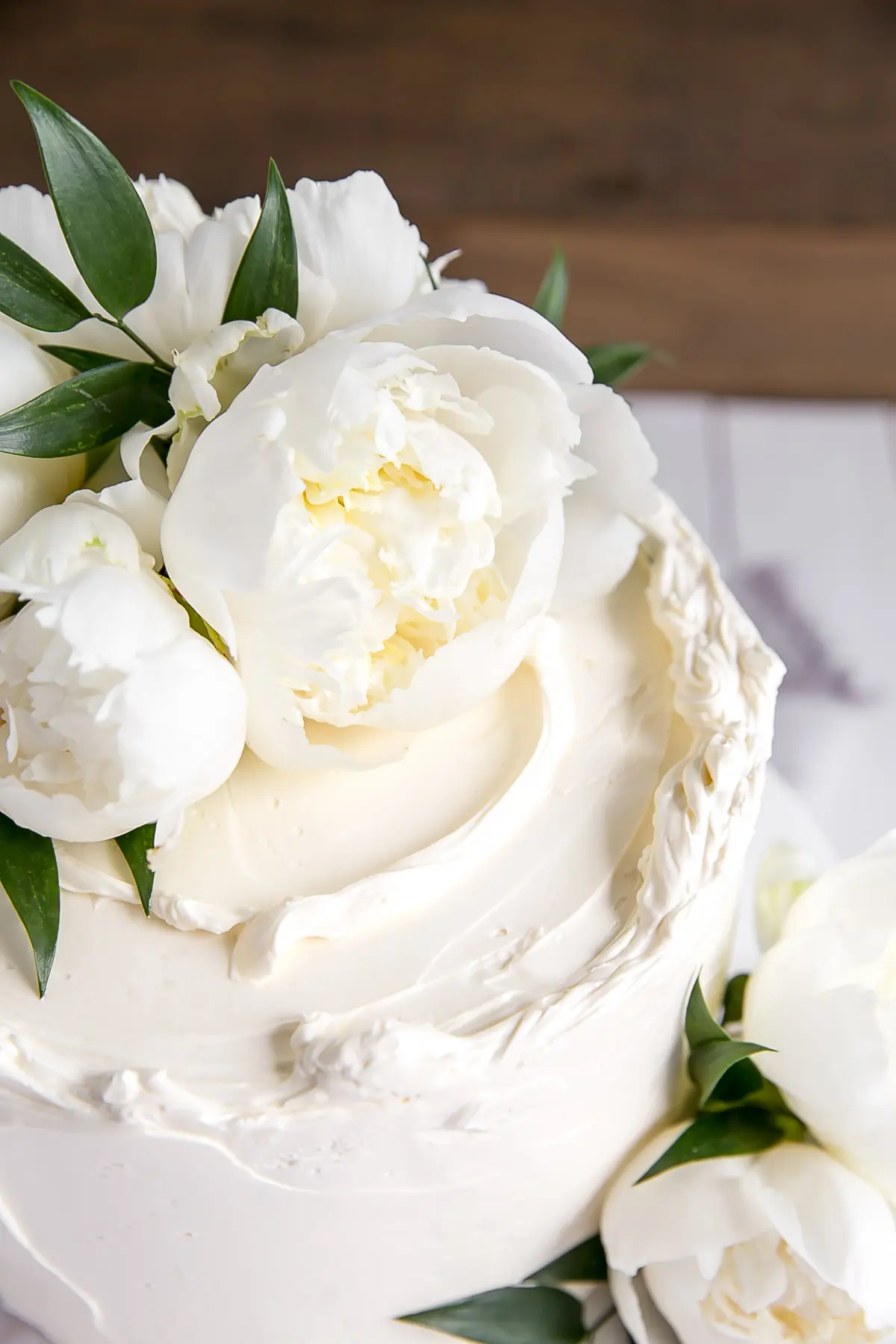 Close up of a Lemon Elderflower Cake with peonies