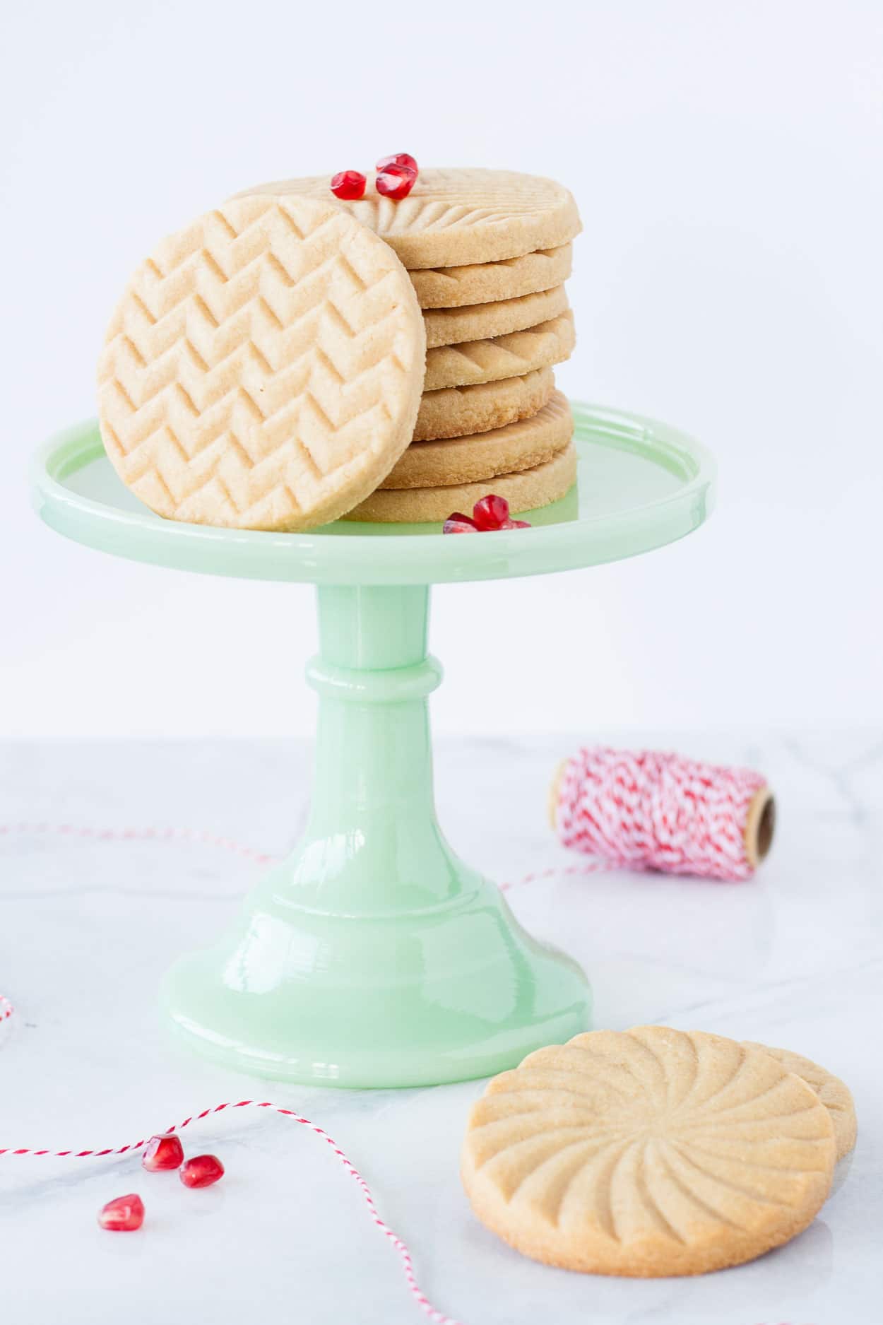 Cookies on a green cake stand.