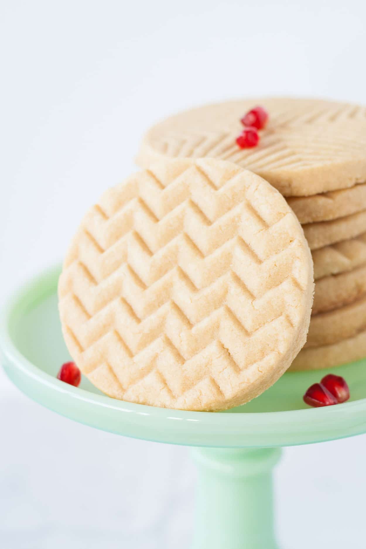 Close up of cookies on a green cake stand.