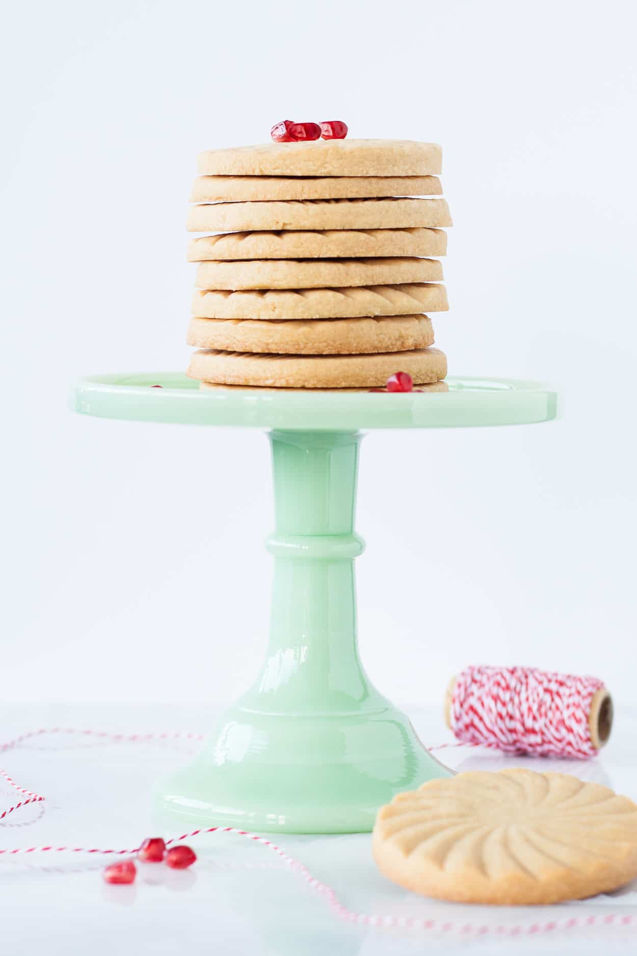 Cookies stacked on a green cake stand.