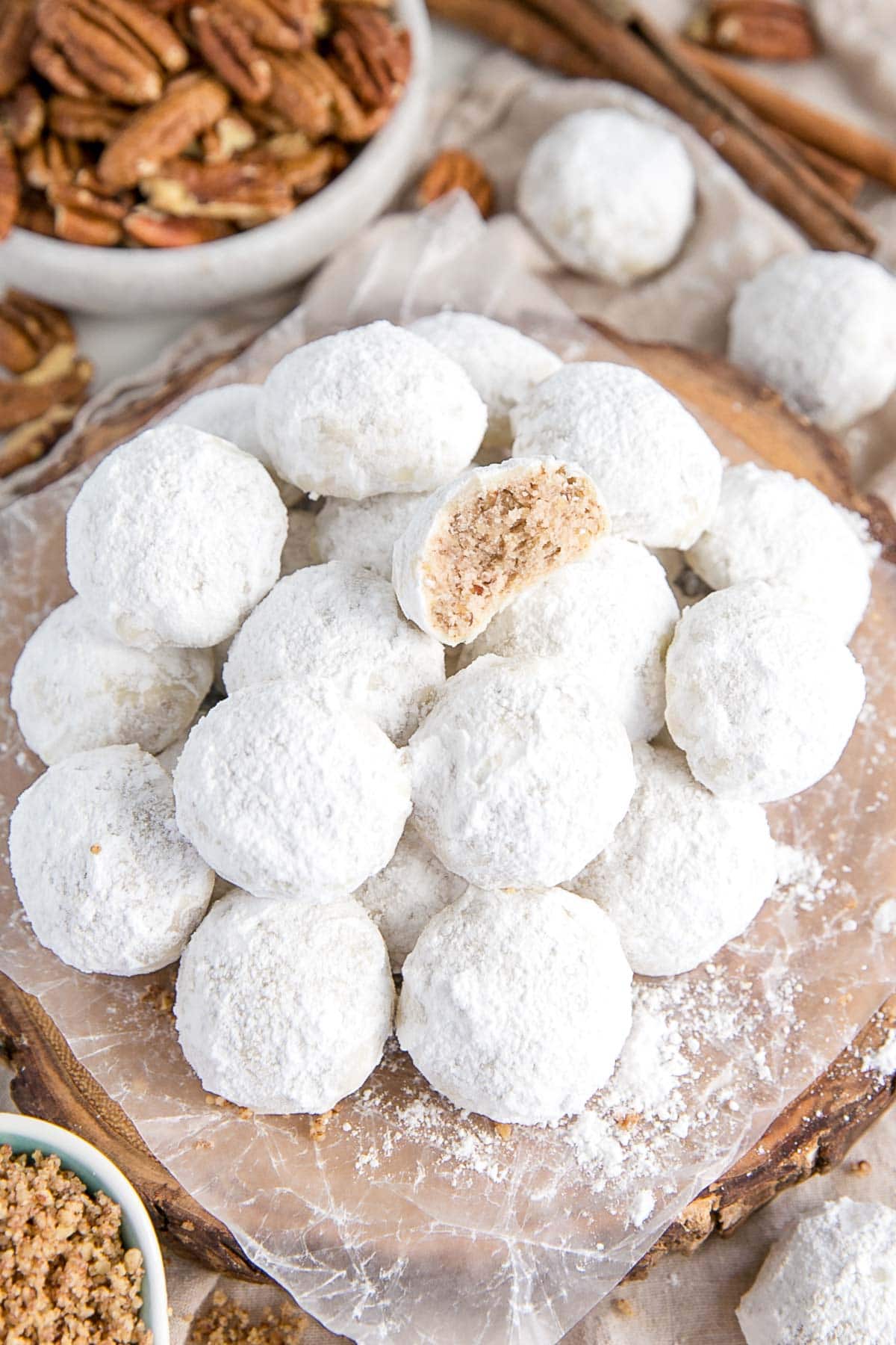 Stack of snowball cookies on a plate.