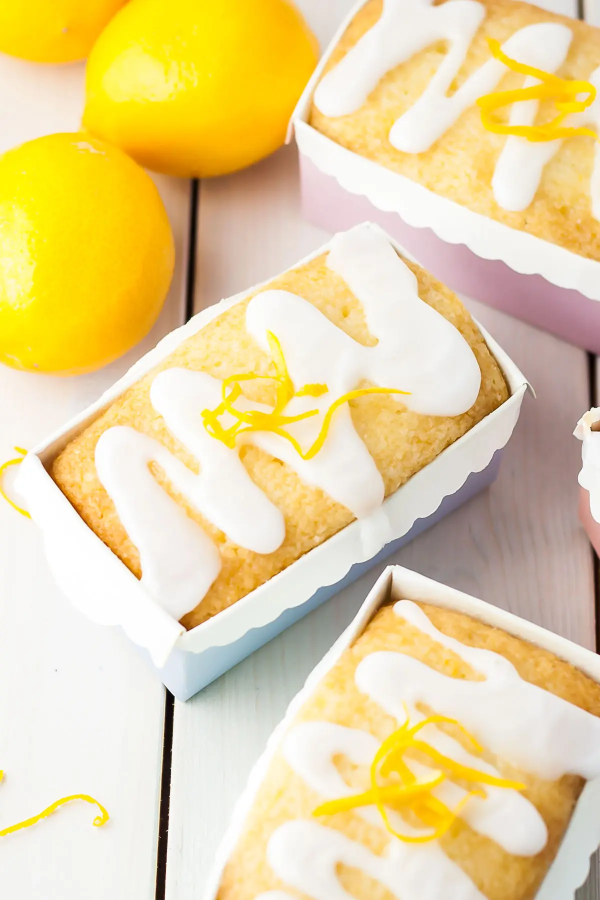 Three mini lemon loaves in pastel liners.