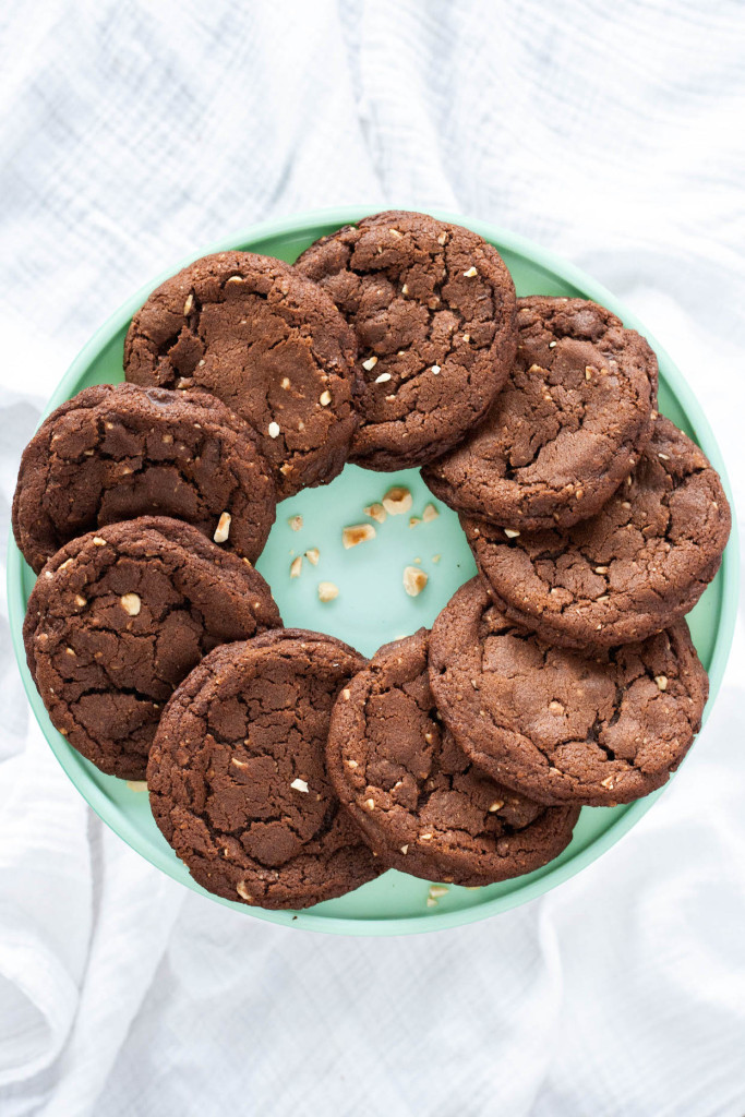 Overhead shot of cookies layered in a circular pattern on a mint green cake stand.