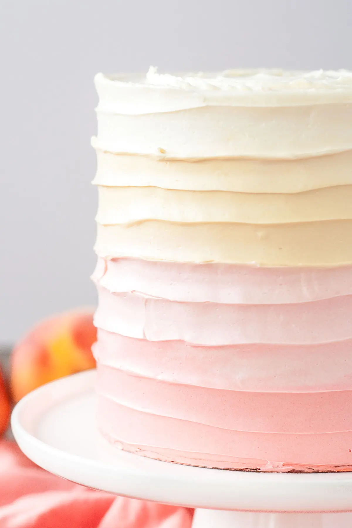 Close up of the swirl frosting technique on an ombre peach cake.