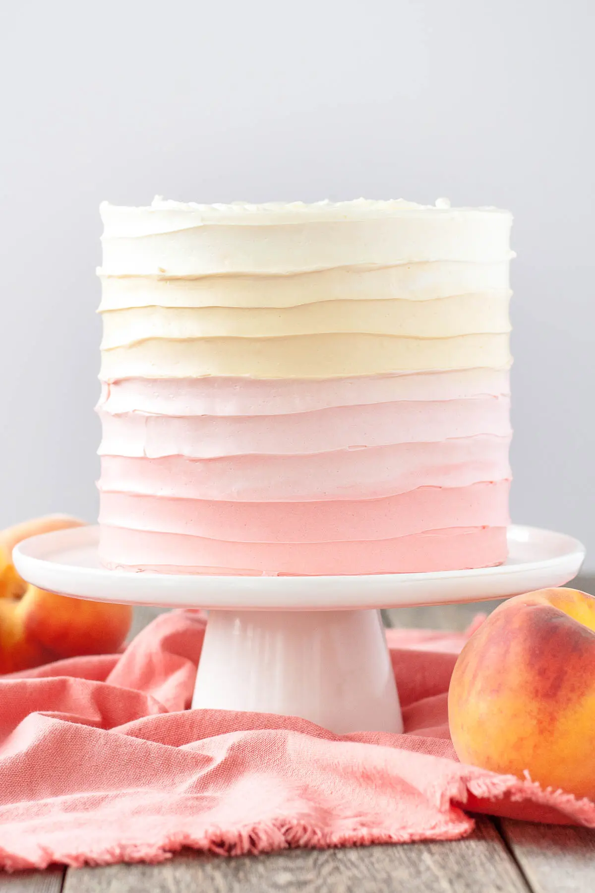 Peach cake with homemade peach filling and ombre peach frosting.