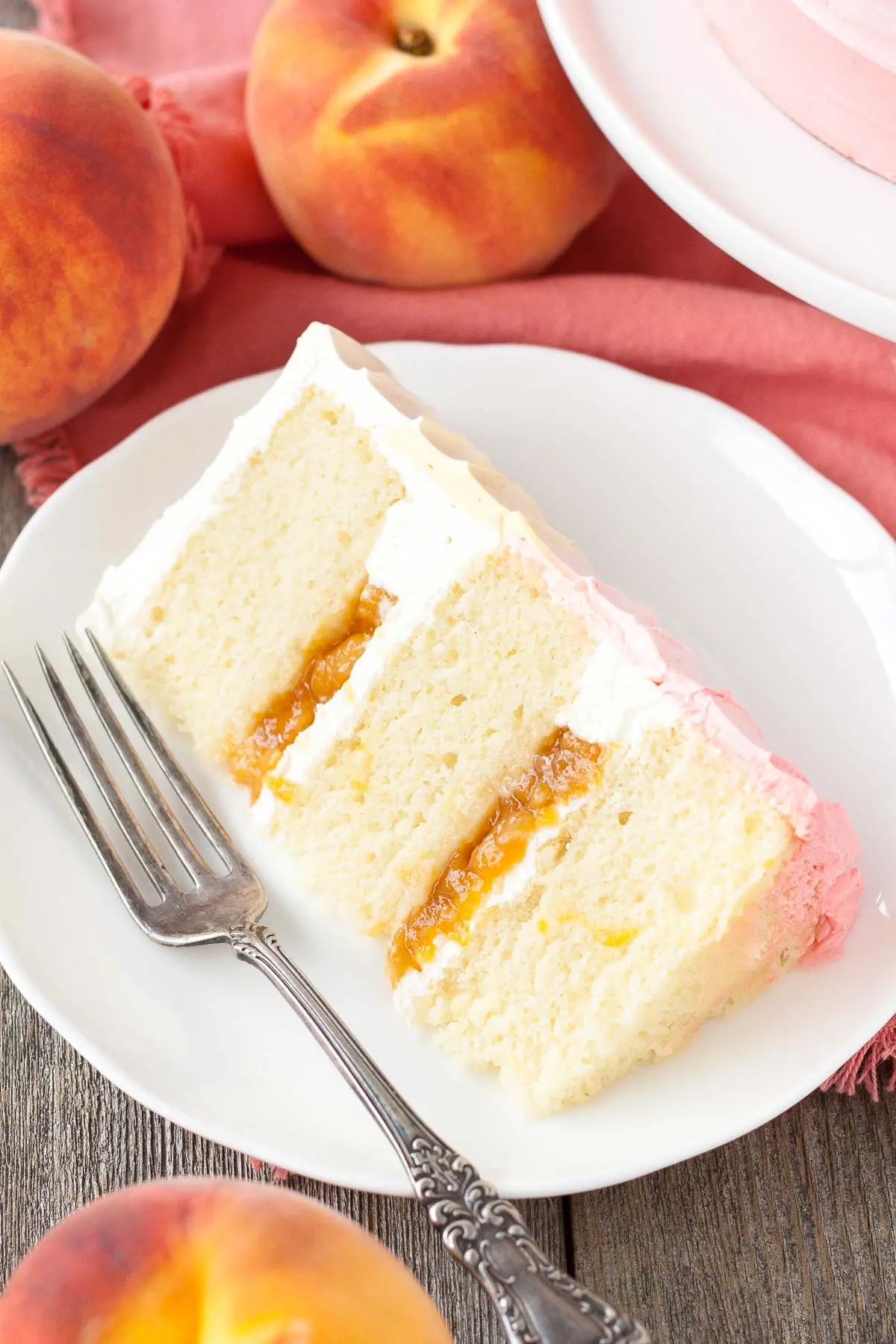 Slice of peach cake on a plate.