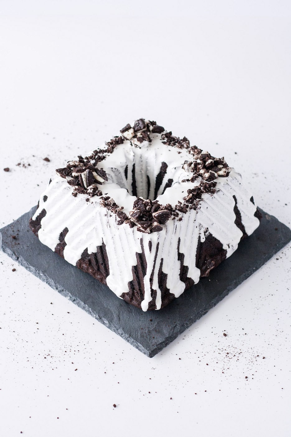 Square bundt cake on a slate plate on a white background.