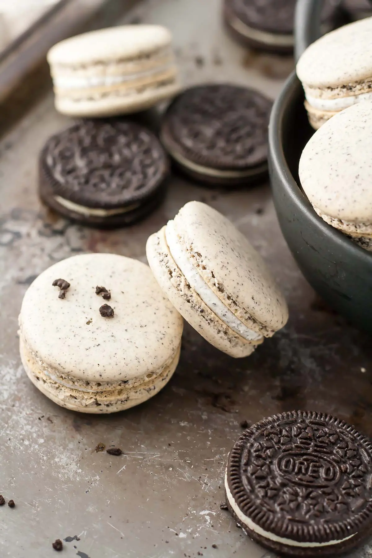 Oreo macarons with Oreo filling on a baking sheet.