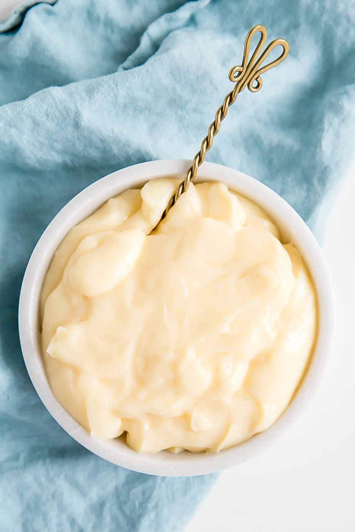 A spoon in a bowl of Creme Patissiere.