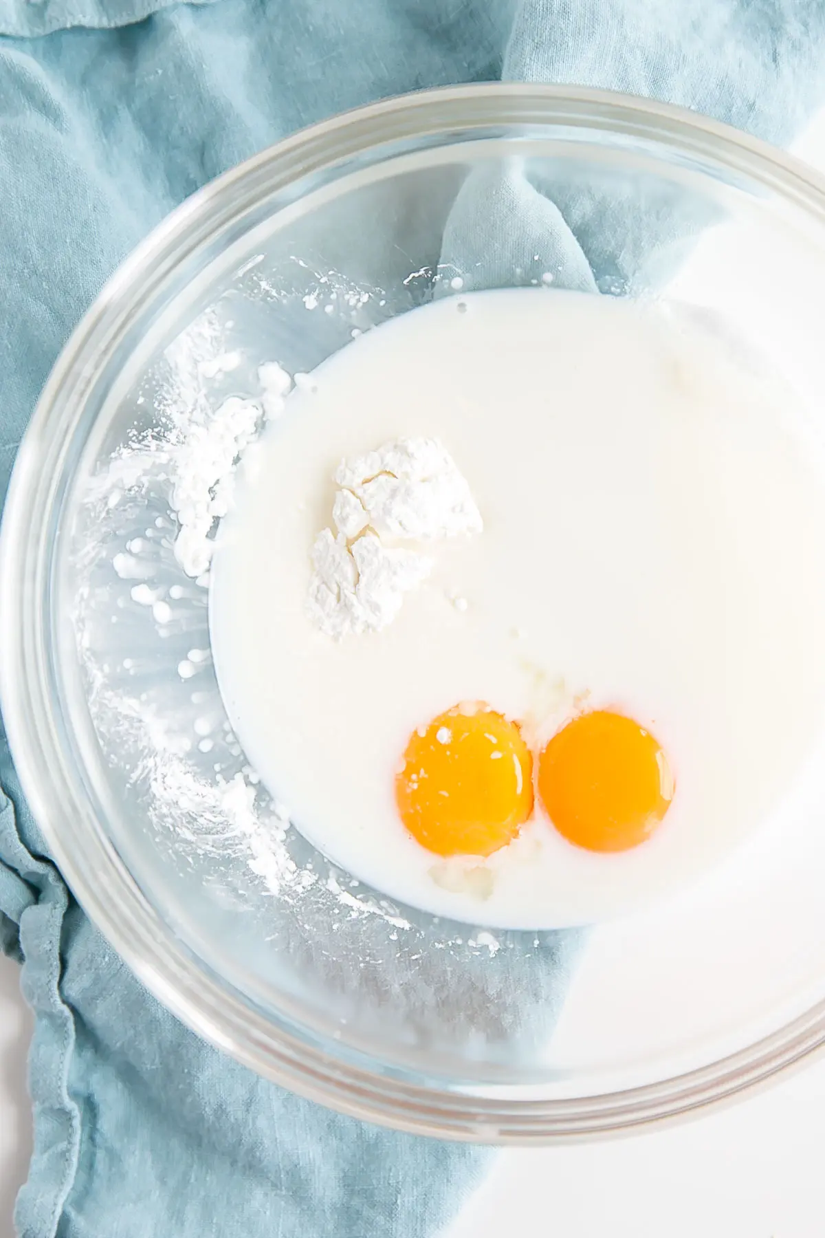 Eggs, cornstarch, and milk in a bowl.