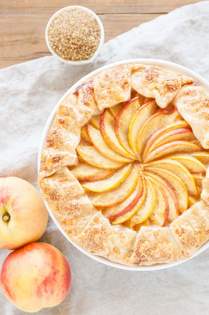 Overhead shot of the galette with peaches next to it.