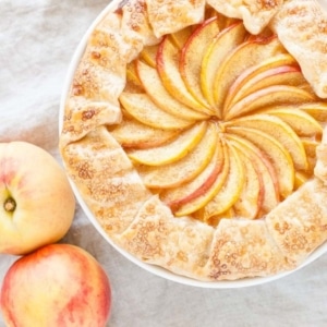 Overhead shot of the galette with peaches next to it.