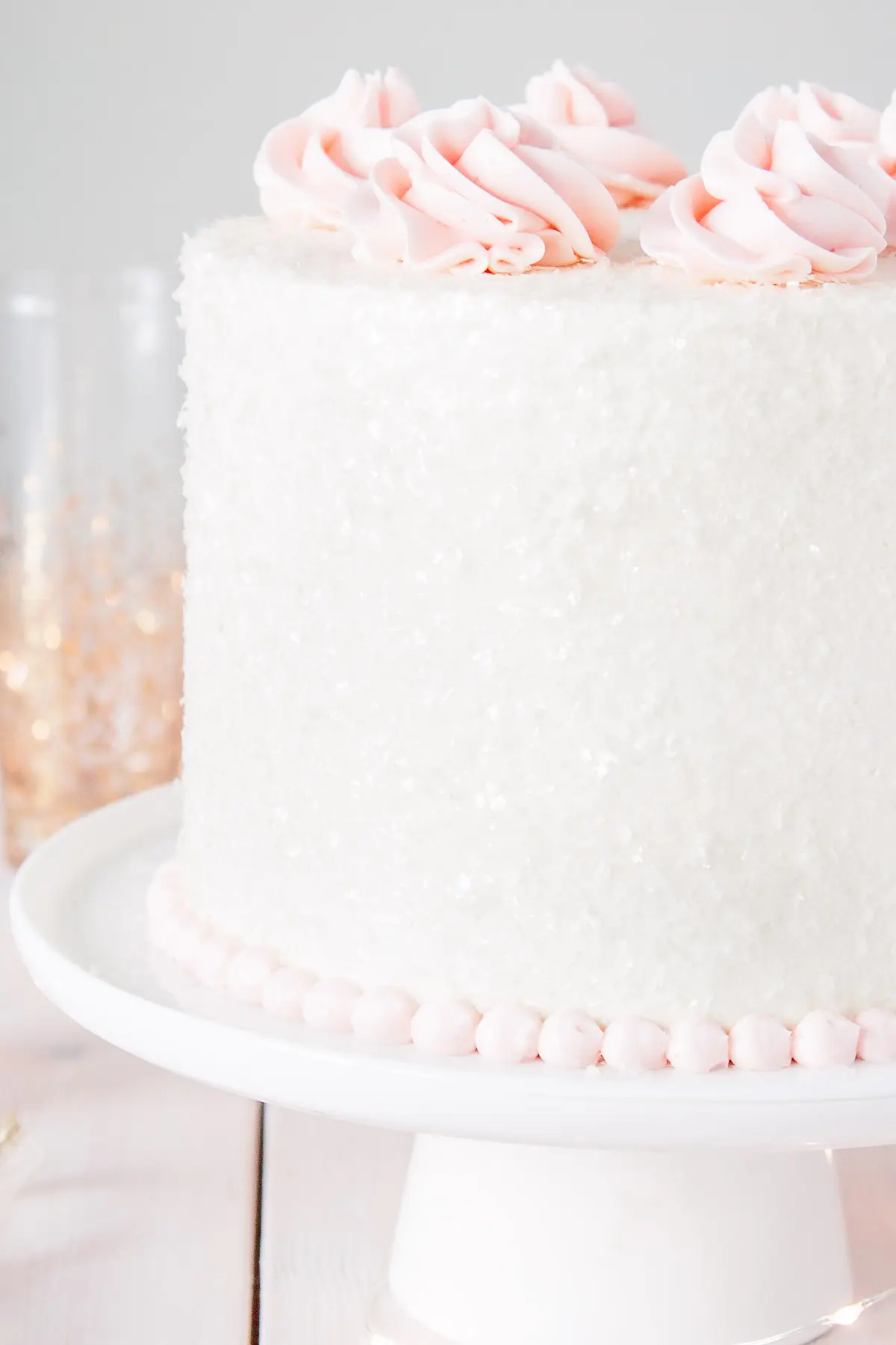 Close up of cake sparkles on a pink champagne cake.