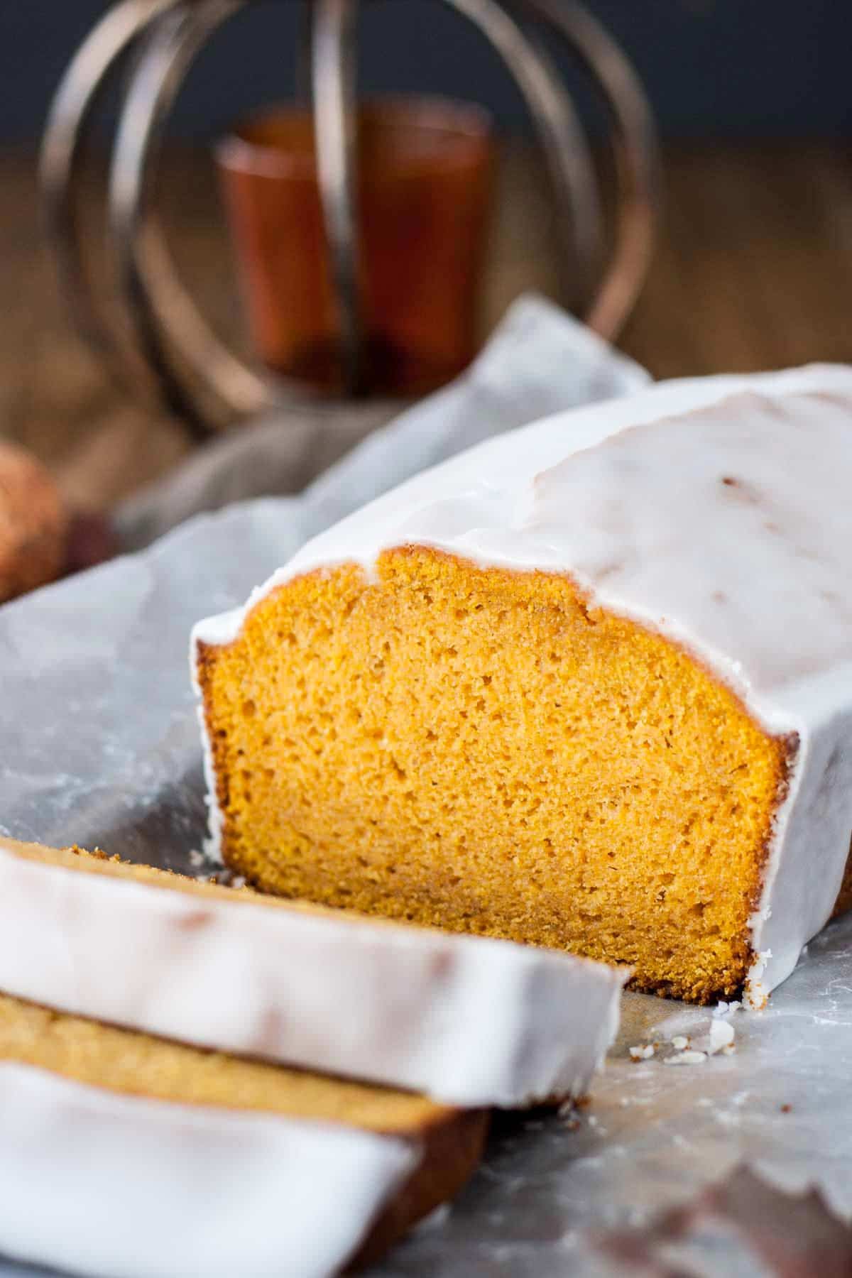 Pumpkin loaf with a couple slices cut from it.