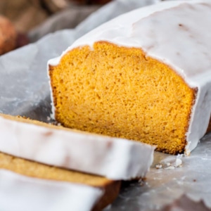 Pumpkin loaf with a couple slices cut from it.