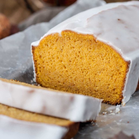 Pumpkin loaf with a couple slices cut from it.