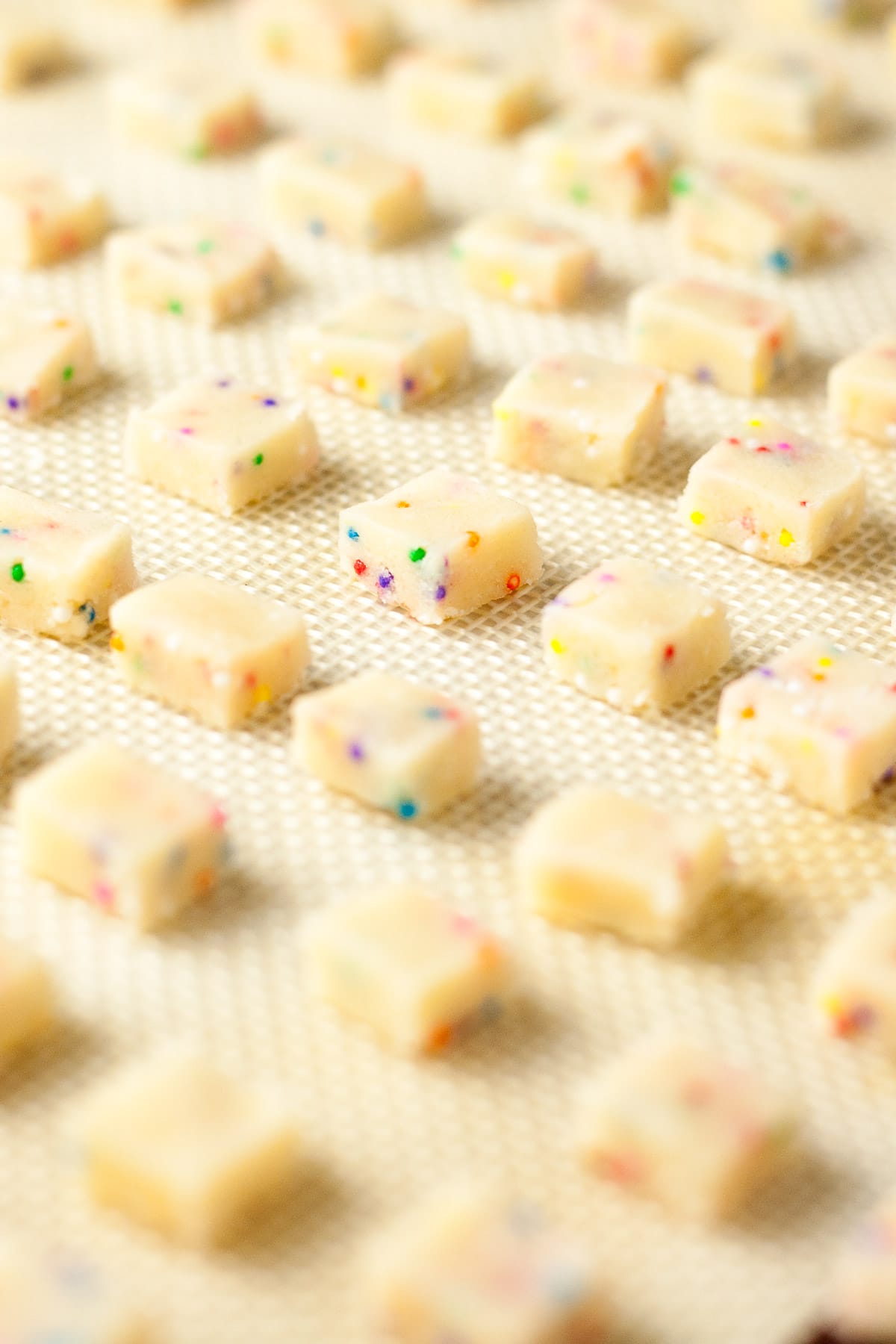 Shortbread bites before baking on a baking sheet.