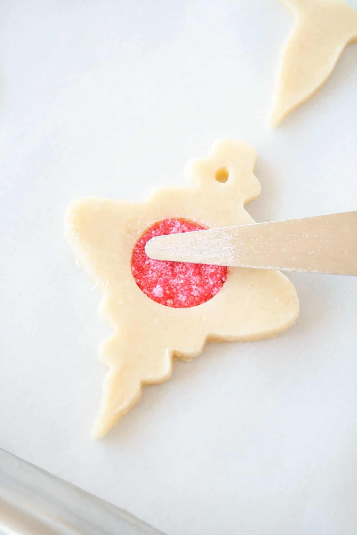 Stained Glass Cookie filled with red sanding sugar before baking.