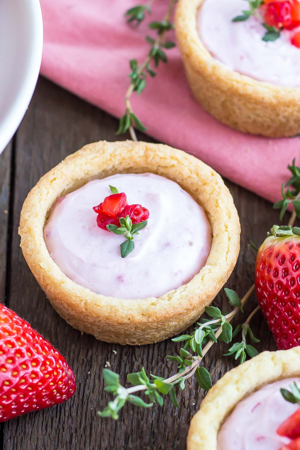 Cookie cup with strawberries beside it